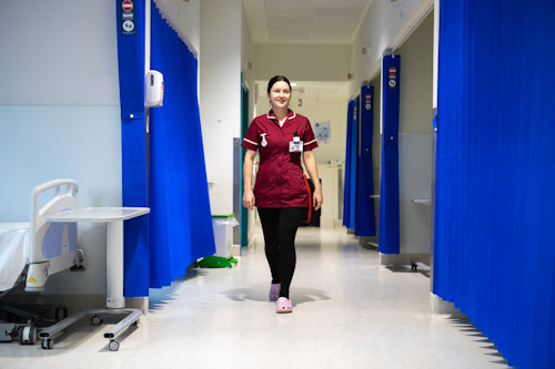 Midwife walking in Murray ward corridor